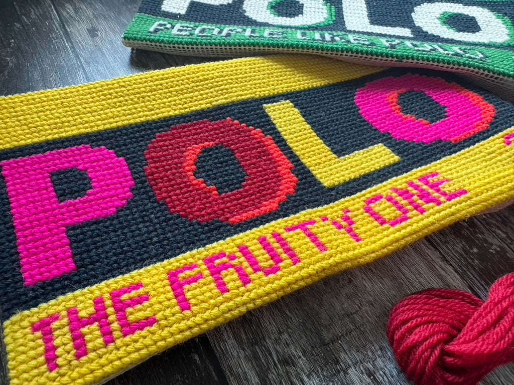 Colorful 'POLO' patches with text on a wooden surface